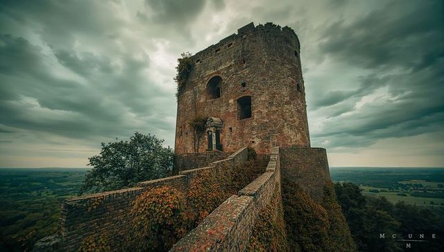 Medieval stone tower ruins with creeping vines