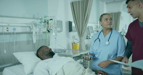 Healthcare Team Discussing Patient Care in Hospital Room