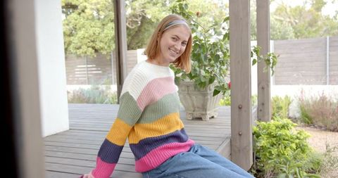 young woman enjoying peaceful moment on rustic wooden deck - Download Free Stock Images Pikwizard.com