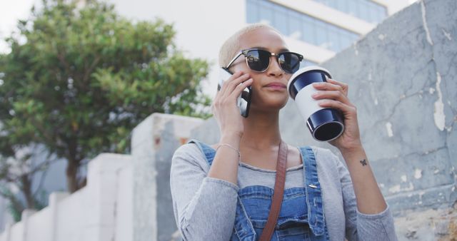 Confident woman talking on phone while drinking coffee outdoors - Download Free Stock Images Pikwizard.com