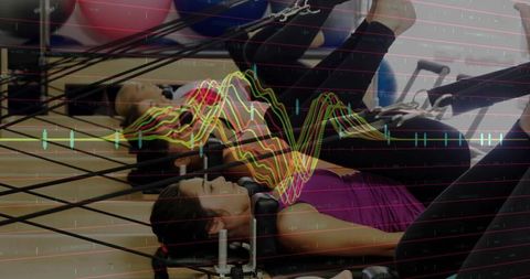 Motivated women exercising on pilates reformers