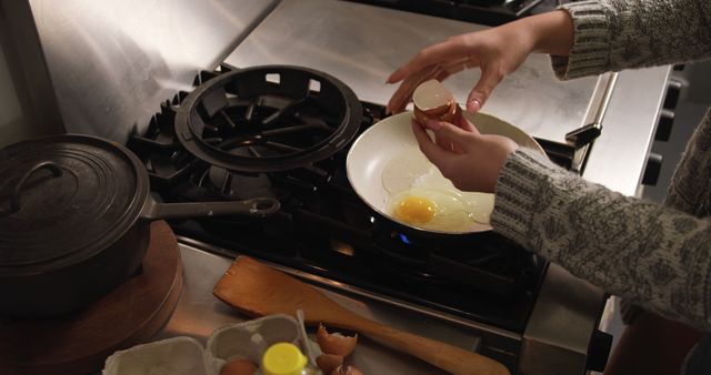 Person Cracking Egg into Frying Pan on Stove - Download Free Stock Images Pikwizard.com