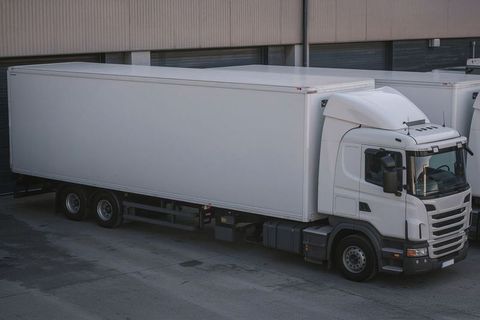 White Semi-Trailer Truck in Industrial Loading Area