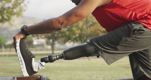 Disabled African American Man Stretching with Prosthetic Leg Outdoors - Download Free Stock Images Pikwizard.com