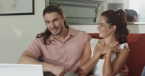 Happy Couple Engaging with Laptop Together at Home