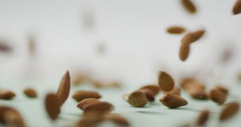 Falling Almonds Creating Dynamic Motion on Blank Background