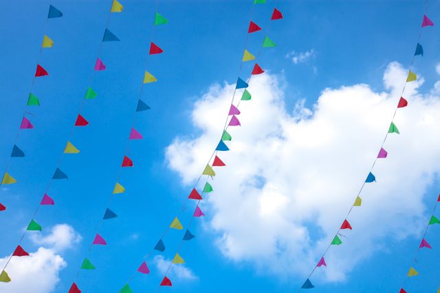 Colorful Festival Triangle Flags Hanging Against Blue Sky - Download Free Stock Photos Pikwizard.com