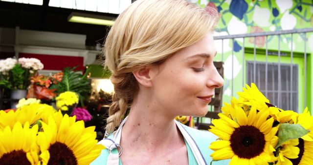 Smiling Blonde Woman with Sunflowers in Hand at Flower Shop - Download Free Stock Images Pikwizard.com