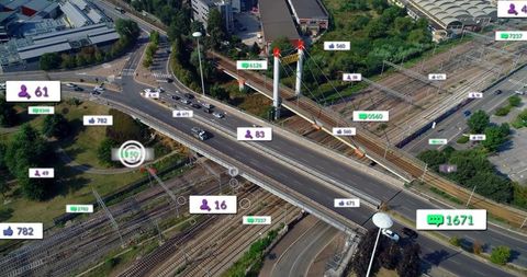 Aerial view showing smart traffic and sensor data overlays on highway overpass and railway