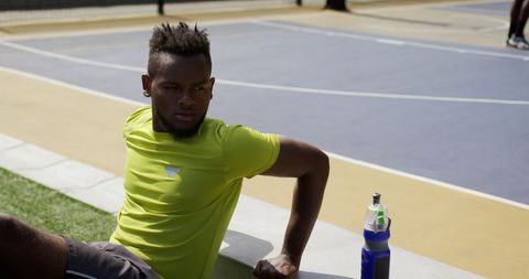 Athletic African American Man Relaxing by Basketball Court