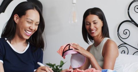 Diverse Female Friends Unpacking during Vacation Stay