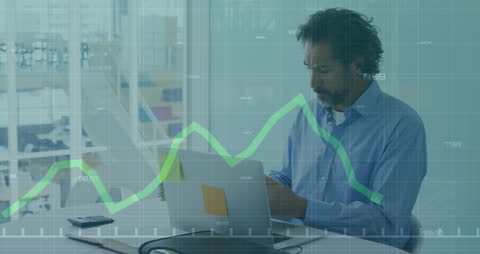 Businessman Analyzing Data on Laptop and Tablet in Modern Office