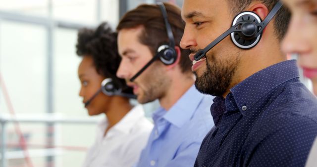 Multiracial Customer Service Team in Call Center Wearing Headsets - Download Free Stock Photos Pikwizard.com
