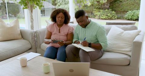 Mature couple managing finances together at home