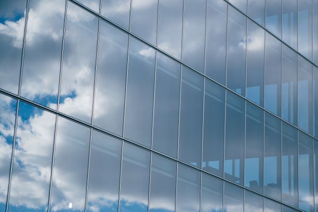 Modern Glass Building Reflecting Cloudy Sky - Download Free Stock Photos Pikwizard.com
