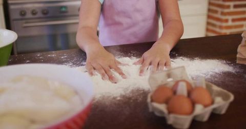 Child Kneading Dough on Floured Countertop in Cozy Kitchen