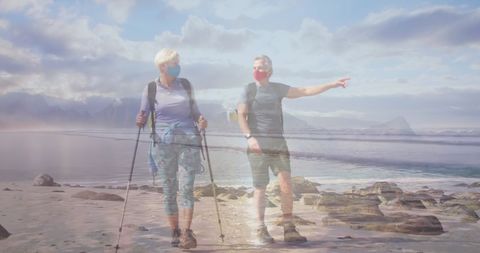 Senior Couple Hiking on Scenic Beach Wearing Face Masks