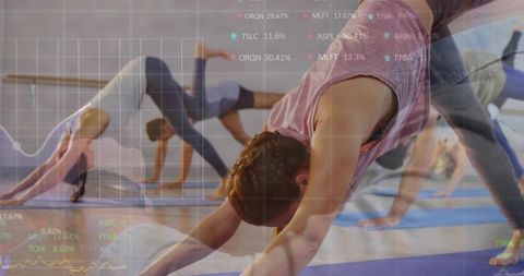 Group yoga class practicing downward dog with fitness data overlay and analytics visual