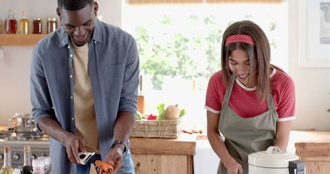 Happy Couple Collaborating in Kitchen Preparing Meal Together