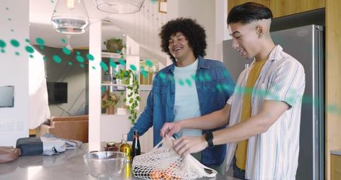Young Friends Unpacking Reusable Produce Bag at Modern Kitchen Island, Smiling