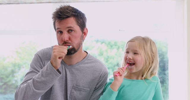 Father and Daughter Brushing Teeth Together in Bright Bathroom - Download Free Stock Images Pikwizard.com