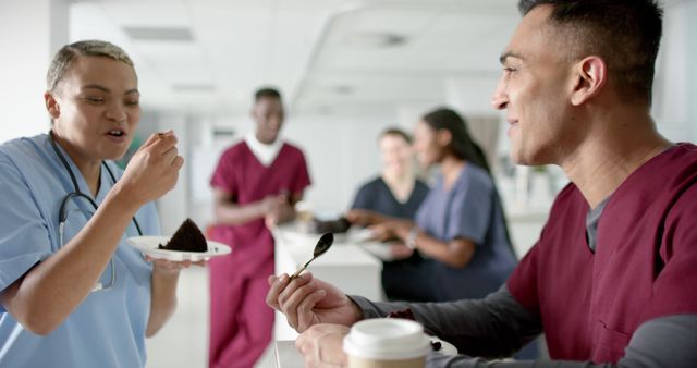 Diverse male and female doctors eating birthday cake at reception desk at hospital - Download Free Stock Photos Pikwizard.com