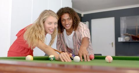 Biracial Friends Laughing While Playing Pool