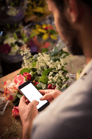 Man in Florist Holding Smartphone with Transparent Screen