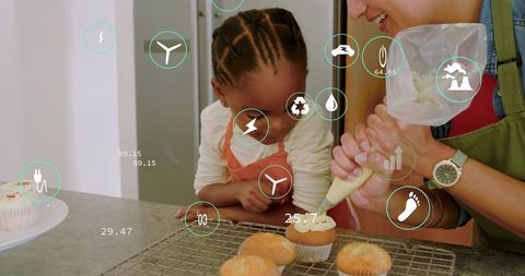 Parent and child baking cupcakes, frosting together with augmented reality overlays