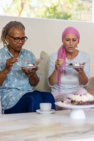 Senior friends enjoying cake and companionship at home