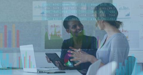 Businesswomen Collaborating on Data Analytics and Dashboards Using Laptop and Tablet