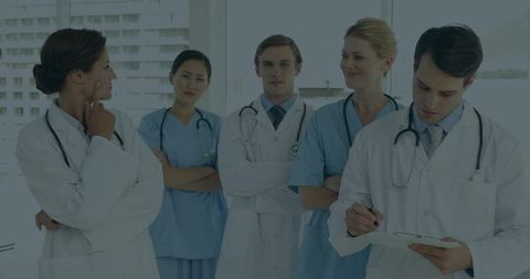 Multidisciplinary Medical Team Standing Discussing Patient Care and Collaboration