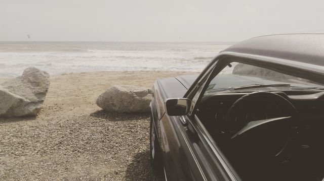 Classic Car Parked by Seaside with Rocky Beach Landscape - Download Free Stock Photos Pikwizard.com