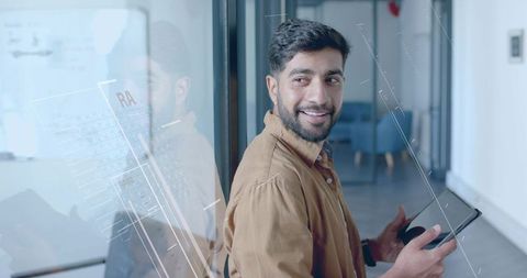 Business Professional with Tablet in Modern Office Hallway