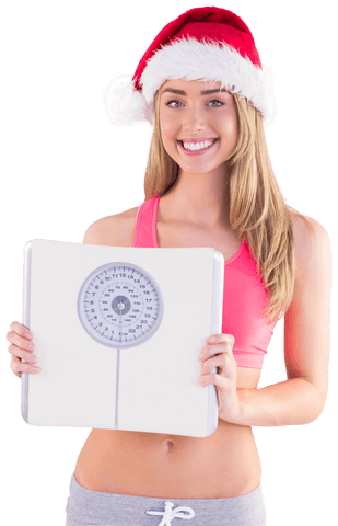 Young woman in santa hat holding scale on transparent background