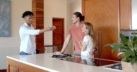 Relaxed Gathering of Friends in Modern Kitchen Setting
