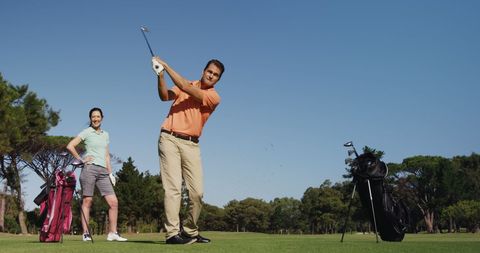 Professional Golfers Practicing on Scenic Course