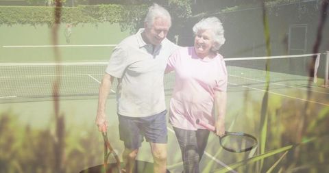 Happy Senior Couple Embracing on Tennis Court with Nature Vibe