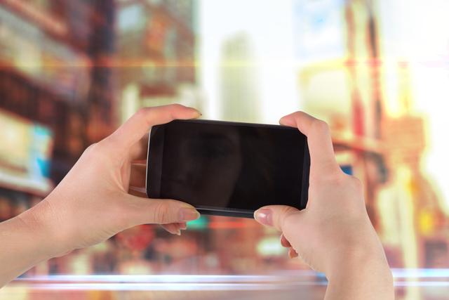 Composite image of hands holding smartphone for a picture