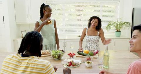 Diverse Friends Enjoying Meal Preparation in Modern Kitchen