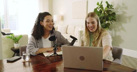 Two women collaborating on podcast at home
