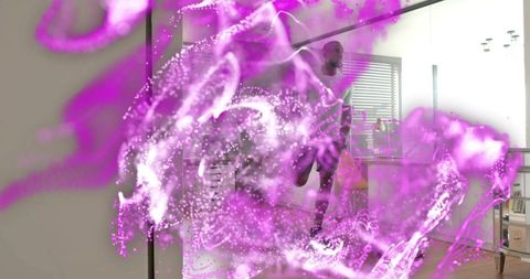 Fit man balancing on one leg in modern open-plan apartment with purple energy swirl