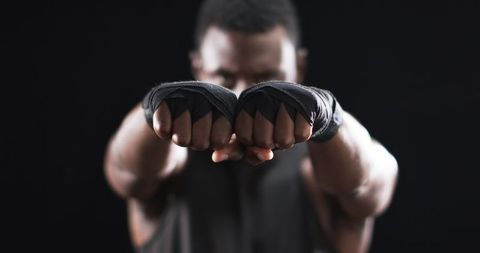 Confident Boxer with Focused Eyes and Wrapped Fists