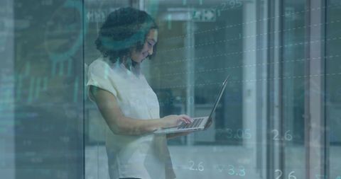 Focused Woman Analyzing Data with Laptop in Modern Office