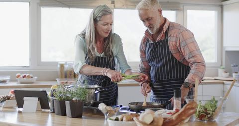 Smiling Middle-aged Couple Cooking Together in Cozy Kitchen - Download Free Stock Images Pikwizard.com