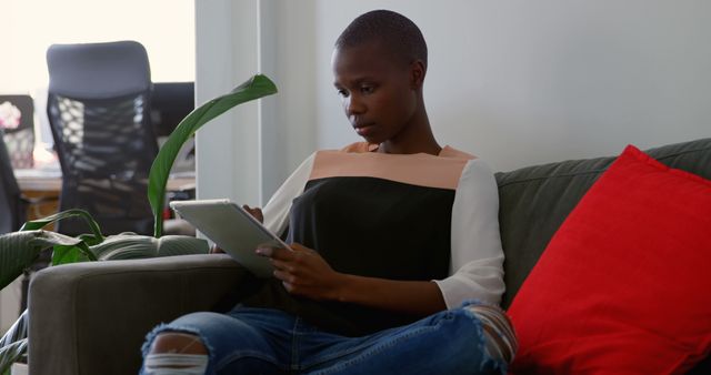 Focused Businesswoman Using Tablet on Cozy Office Couch - Download Free Stock Images Pikwizard.com