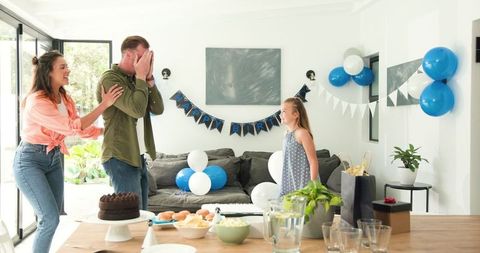 Surprised Father Celebrating Birthday With Enthusiastic Family