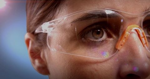 Close-Up of Woman Wearing Safety Glasses in Industrial Setting