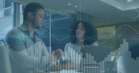 Colleagues discussing data analytics and strategy using laptop with digital charts overlay
