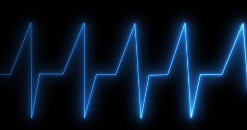 Glowing blue cardiograph against black background